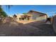 Exterior shot of a fenced-in backyard with a covered patio and room to add grass or a pool at 6784 W Gardenia Ave, Glendale, AZ 85303