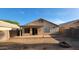 View of the exterior backyard with a covered patio, sliding glass door, and lots of space at 6784 W Gardenia Ave, Glendale, AZ 85303