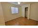 Comfortable bedroom with hardwood floors, a closet, and a window providing natural light, complete with a ceiling fan at 6784 W Gardenia Ave, Glendale, AZ 85303