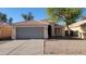 Charming single-story home with a two-car garage and low-maintenance desert landscaping, featuring a beautiful blue sky at 6784 W Gardenia Ave, Glendale, AZ 85303