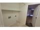 Functional laundry room with tile floors, a shelf for storage, and utility hookups at 6784 W Gardenia Ave, Glendale, AZ 85303