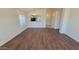 Open-concept living space with hardwood floors, bright lighting, and a breakfast bar connecting the kitchen at 6784 W Gardenia Ave, Glendale, AZ 85303