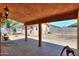 Covered back patio with brick flooring, offering a shaded outdoor living space at 7038 W Fillmore St, Phoenix, AZ 85043
