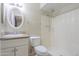 Bathroom with a vanity, a toilet, and a shower-tub combo with a shower curtain rod at 7038 W Fillmore St, Phoenix, AZ 85043