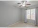 Cozy bedroom with neutral paint, ceiling fan, and natural light at 7038 W Fillmore St, Phoenix, AZ 85043