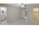 Spacious bedroom with tile floors, ceiling fan, and a doorway leading to an attached bathroom at 7038 W Fillmore St, Phoenix, AZ 85043