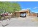Cozy single-story home with a covered parking area and mature trees in a residential neighborhood at 7038 W Fillmore St, Phoenix, AZ 85043