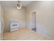 Kitchen view showcasing tile floors, white oven, and ceiling fan with doorway to another room at 7038 W Fillmore St, Phoenix, AZ 85043