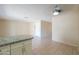 Kitchen with white cabinets, granite countertops, and a view of the living area at 7038 W Fillmore St, Phoenix, AZ 85043
