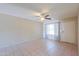 Inviting living room with tiled floors, a ceiling fan, and a bright window at 7038 W Fillmore St, Phoenix, AZ 85043