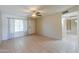 Bright living room with tile flooring, neutral walls, and a window with curtains at 7038 W Fillmore St, Phoenix, AZ 85043