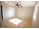 Bedroom featuring ceiling fan, dual closet and a view of the front yard at 7136 W Cheryl Dr, Peoria, AZ 85345