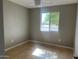 Minimalist bedroom with neutral walls, tile flooring and a window at 7136 W Cheryl Dr, Peoria, AZ 85345