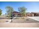 Charming single-story home with a well-manicured front yard and a spacious driveway at 7136 W Cheryl Dr, Peoria, AZ 85345
