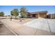 Exterior view of a well-maintained single-story home with a lush green lawn at 7136 W Cheryl Dr, Peoria, AZ 85345