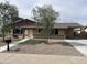 Charming single-story home with low-maintenance rock landscaping and a covered carport at 7136 W Cheryl Dr, Peoria, AZ 85345