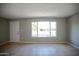 Inviting living room boasts natural light from a large window and neutral tile floors at 7136 W Cheryl Dr, Peoria, AZ 85345