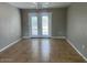 Neutral living room with tile floor, french doors to the backyard and ceiling fan at 7136 W Cheryl Dr, Peoria, AZ 85345