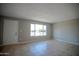 Bright living room with tiled floors, large window, and welcoming front door at 7136 W Cheryl Dr, Peoria, AZ 85345