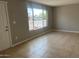 Bright living room with natural light, neutral walls, and tile flooring, awaiting personalization at 7136 W Cheryl Dr, Peoria, AZ 85345