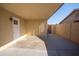 Covered patio area with white doors and neutral walls, ideal for outdoor living at 7136 W Cheryl Dr, Peoria, AZ 85345