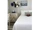 Comfortable bedroom with sports themed decor, a decorative dresser, and a white bedspread at 8700 E University Dr # 124, Mesa, AZ 85207