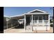 Charming home exterior with covered carport, covered front porch and desert landscaping at 8700 E University Dr # 124, Mesa, AZ 85207
