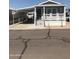 Home exterior featuring covered carport with chairs and table, and covered front porch at 8700 E University Dr # 124, Mesa, AZ 85207