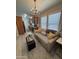 Comfortable living room with wood floors, modern decor, chandelier, and kitchen access at 8700 E University Dr # 124, Mesa, AZ 85207