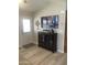 Living room with wood floors, display cabinet, and wall art at 8700 E University Dr # 124, Mesa, AZ 85207