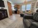 Cozy living room featuring light wood floors, a chandelier, and open access to the kitchen at 8700 E University Dr # 124, Mesa, AZ 85207