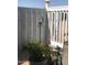 Enclosed patio area with an outdoor chair, potted plants, and decorative wind chimes at 8700 E University Dr # 124, Mesa, AZ 85207