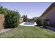 Well-maintained backyard featuring a pool, lush lawn, and mature trees at 880 W Moon Shadow Dr, Casa Grande, AZ 85122