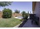 Spacious backyard with mature trees, grass, and a swimming pool at 880 W Moon Shadow Dr, Casa Grande, AZ 85122