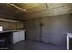 Unfinished basement workshop with pegboard, cabinets, and workbench at 880 W Moon Shadow Dr, Casa Grande, AZ 85122