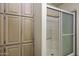 Bright bathroom features shower with sliding glass door and built in linen cabinet for storage and organization at 880 W Moon Shadow Dr, Casa Grande, AZ 85122
