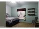 Cozy bedroom with a comfortable bed, matching curtains, and shelving for a welcoming retreat at 880 W Moon Shadow Dr, Casa Grande, AZ 85122