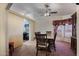 Spacious dining room featuring a ceiling fan and view into the kitchen and table area at 880 W Moon Shadow Dr, Casa Grande, AZ 85122