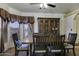 Traditional dining room with wood table, comfortable chairs, and elegant china cabinet at 880 W Moon Shadow Dr, Casa Grande, AZ 85122