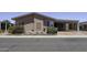 Charming single-story home with a covered carport and desert landscaping featuring a colorful flowering bush at 880 W Moon Shadow Dr, Casa Grande, AZ 85122