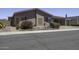 Charming single-story home with a covered carport and desert landscaping featuring a colorful flowering bush at 880 W Moon Shadow Dr, Casa Grande, AZ 85122
