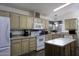 Bright kitchen with white appliances, light-colored cabinetry, and a central island at 880 W Moon Shadow Dr, Casa Grande, AZ 85122