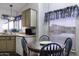 Eat-in kitchen with tile table and countertops, white appliances, and plenty of light at 880 W Moon Shadow Dr, Casa Grande, AZ 85122