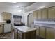 Charming kitchen with an island, tile backsplash, and abundant cabinet storage space at 880 W Moon Shadow Dr, Casa Grande, AZ 85122