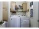 Functional laundry room with washer, dryer, shelving for storage, and exterior door for easy access at 880 W Moon Shadow Dr, Casa Grande, AZ 85122
