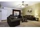 Inviting living room with plush seating, a ceiling fan, and warm lighting at 880 W Moon Shadow Dr, Casa Grande, AZ 85122