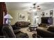 Inviting living room with plush seating, a ceiling fan, and warm lighting at 880 W Moon Shadow Dr, Casa Grande, AZ 85122