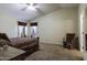 Large primary bedroom with neutral walls, carpet, and a rocking chair at 880 W Moon Shadow Dr, Casa Grande, AZ 85122