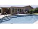 Sparkling pool with access stairs, a table setting, and well-maintained landscaping at 880 W Moon Shadow Dr, Casa Grande, AZ 85122