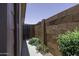 Side yard with brick wall, lush shrubs, and gated entry at 880 W Moon Shadow Dr, Casa Grande, AZ 85122